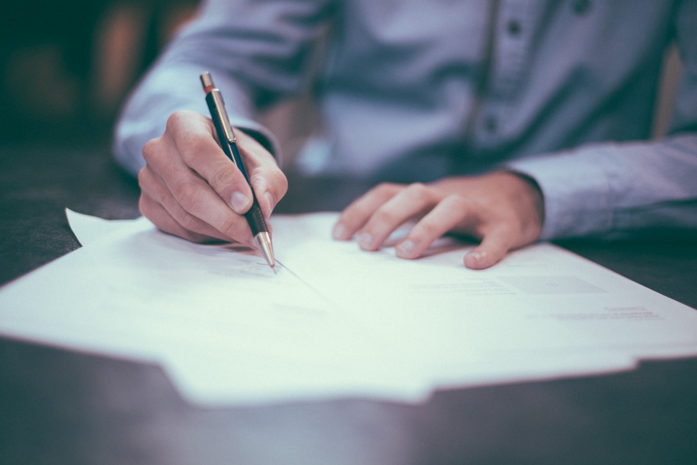Signing off on a document at a desk